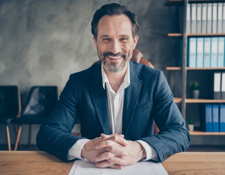 smiling mature male in office sitting at desk-big-1