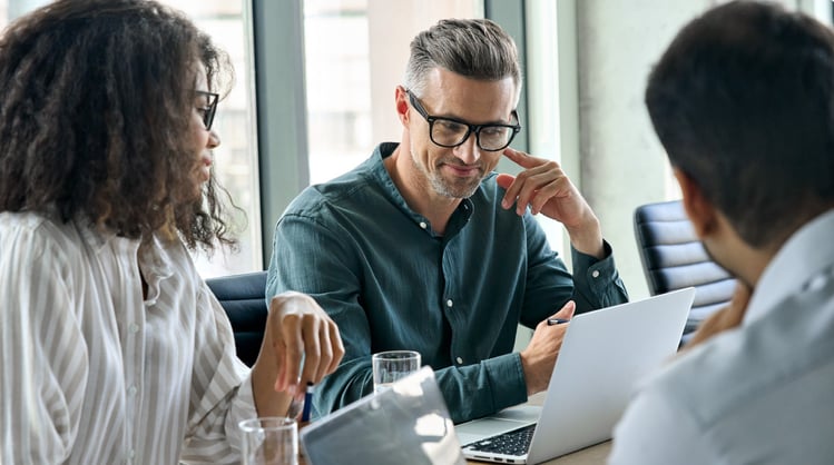 diverse team of professionals in office setting at conference table