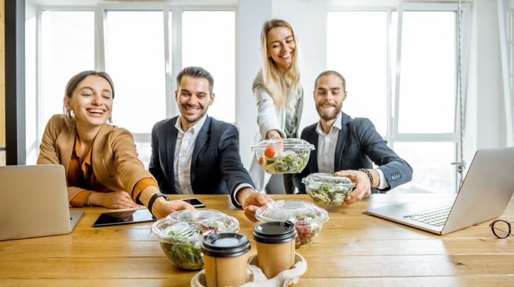 smiling-healthy-young-men-and-women-at-office-lunch-area-eating-salads
