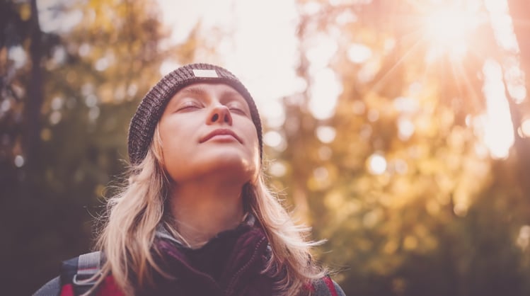 young blonde female outdoors winter apparel taking seep breath big